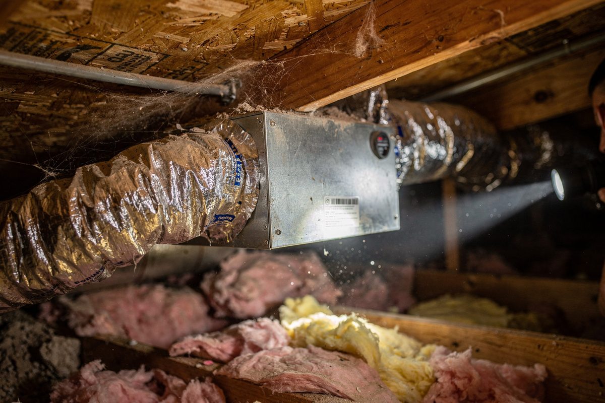 Energy-recovery ventilator unit installed in an attic with ductwork connections