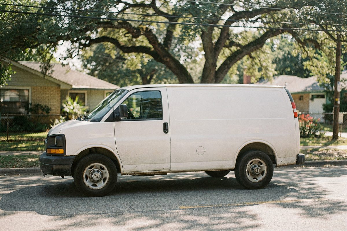 Service van driving down a residential Austin street